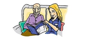 Care worker reading with service user
