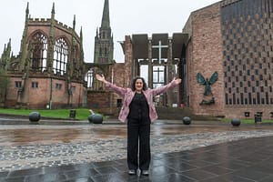 new or old standign in front of old and new Coventry Catherdral